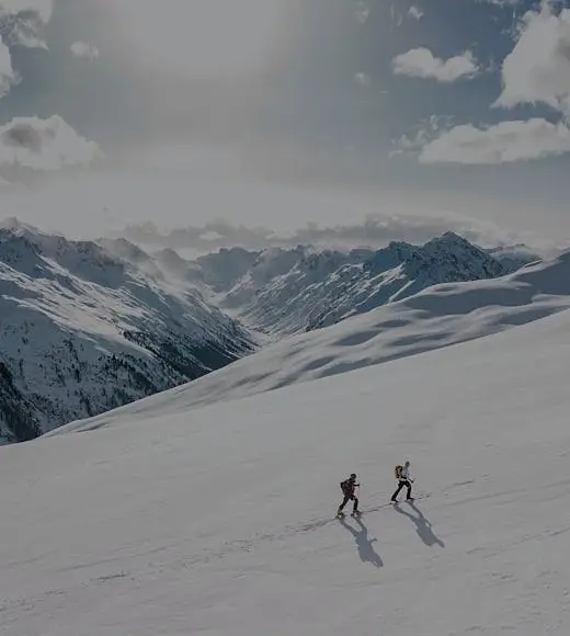 Hikers ascending a snowy ridge